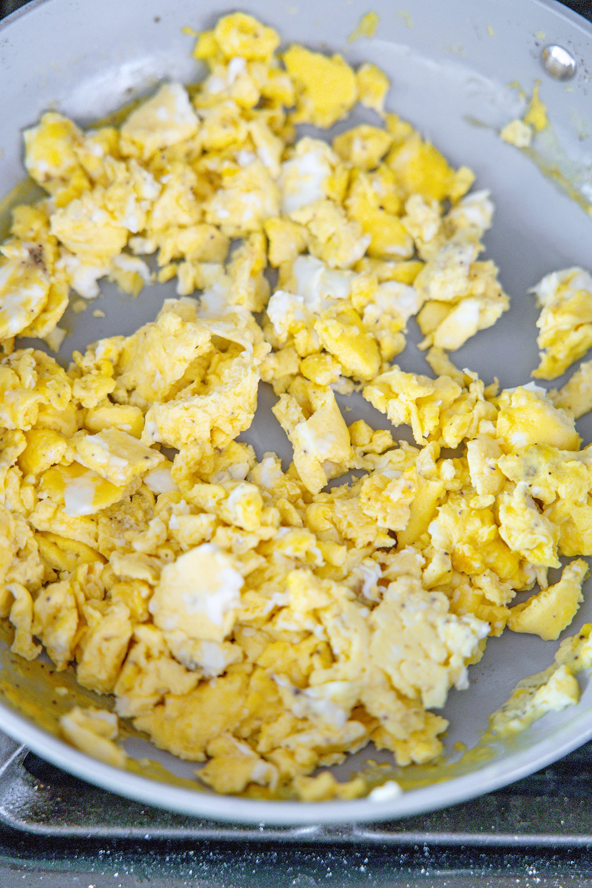 Scrambled eggs in skillet.