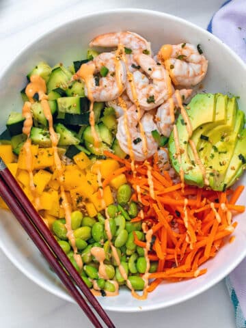 Overhead view of shrimp poke bowls with lots of bright colors.