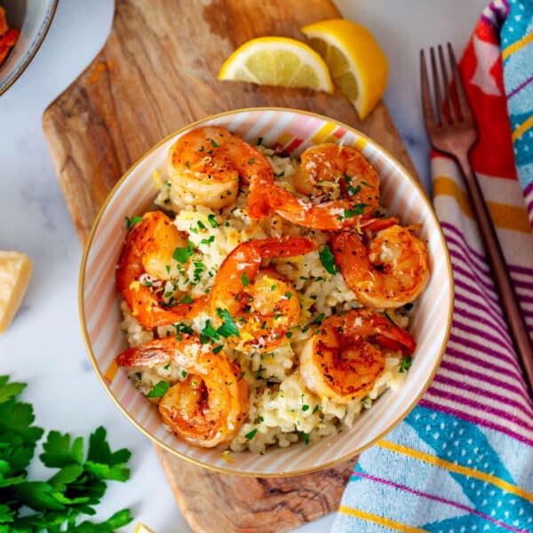 Overhead view of a bowl of risotto topped with shrimp.