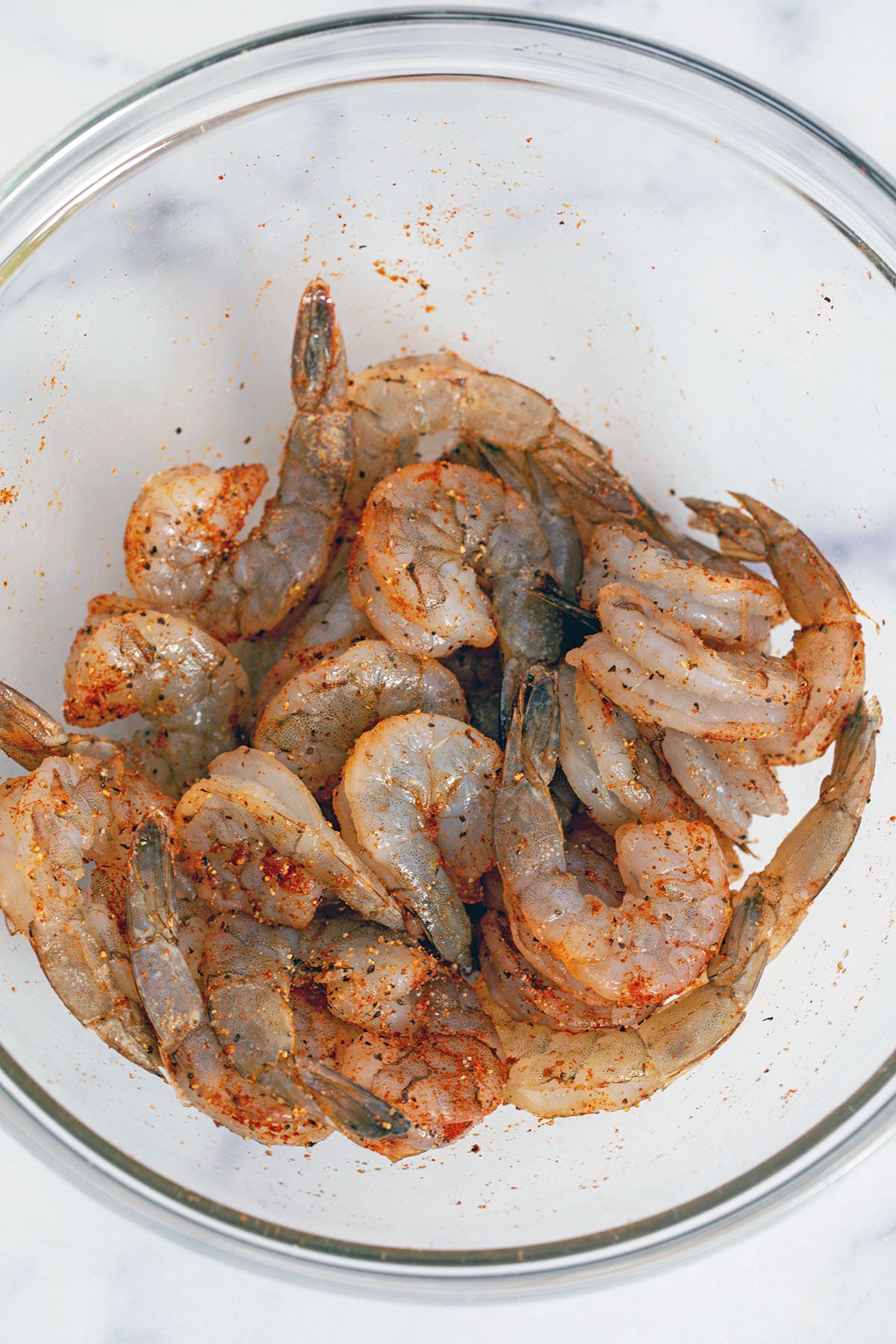 Shrimp marinating in bowl.
