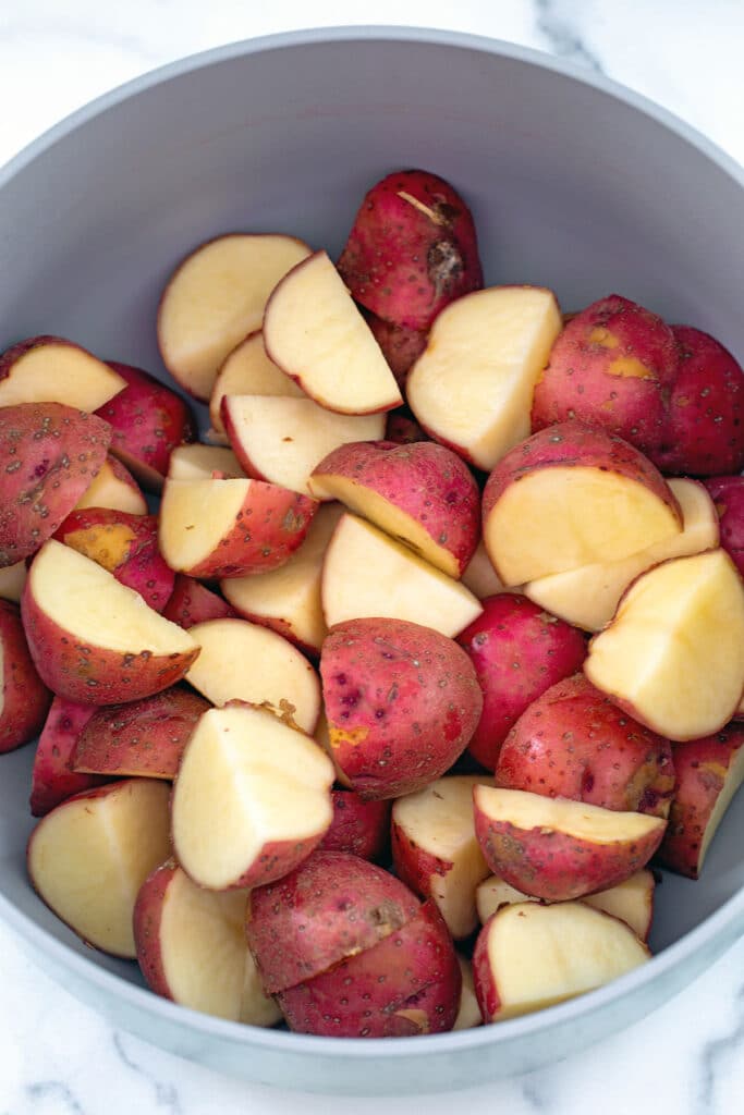 Quartered red skin potatoes in large pot.