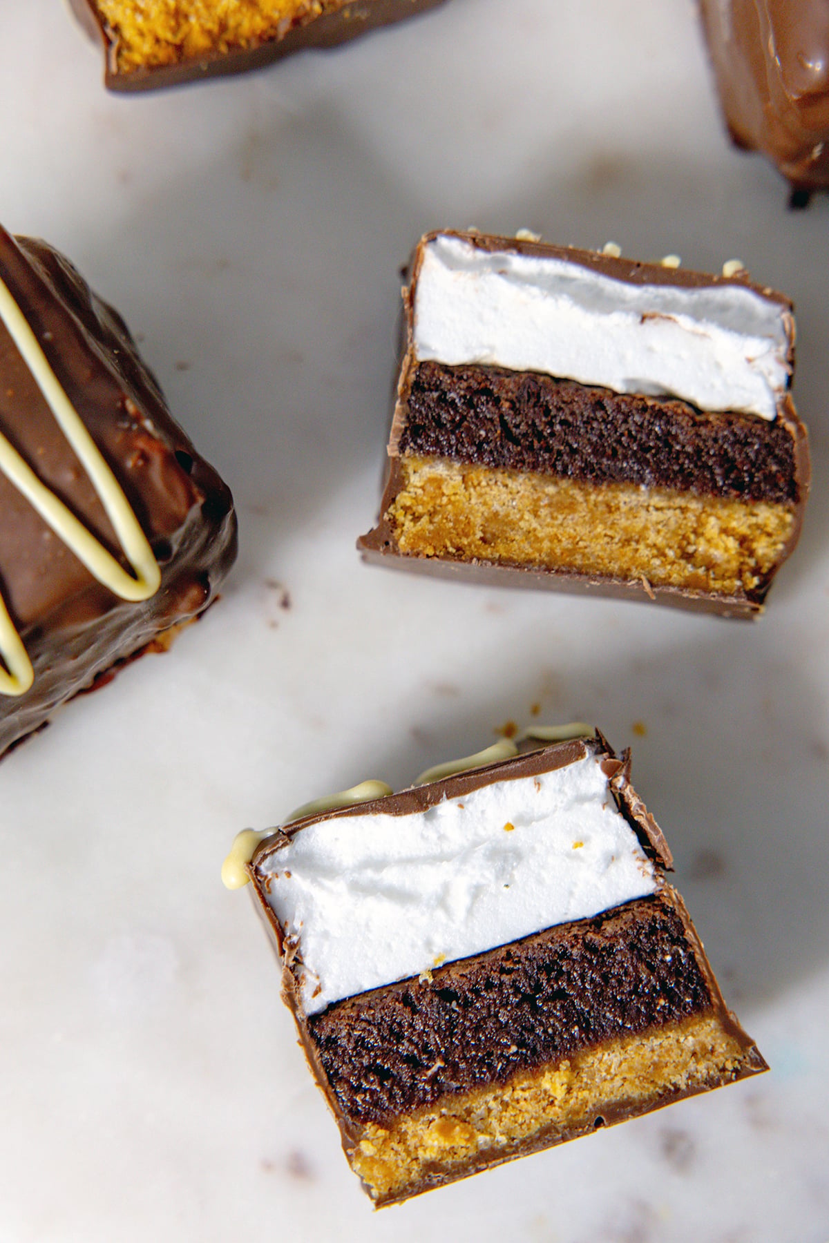 Birds' eye view of multiple s'mores brownie bars laying down to show layers.