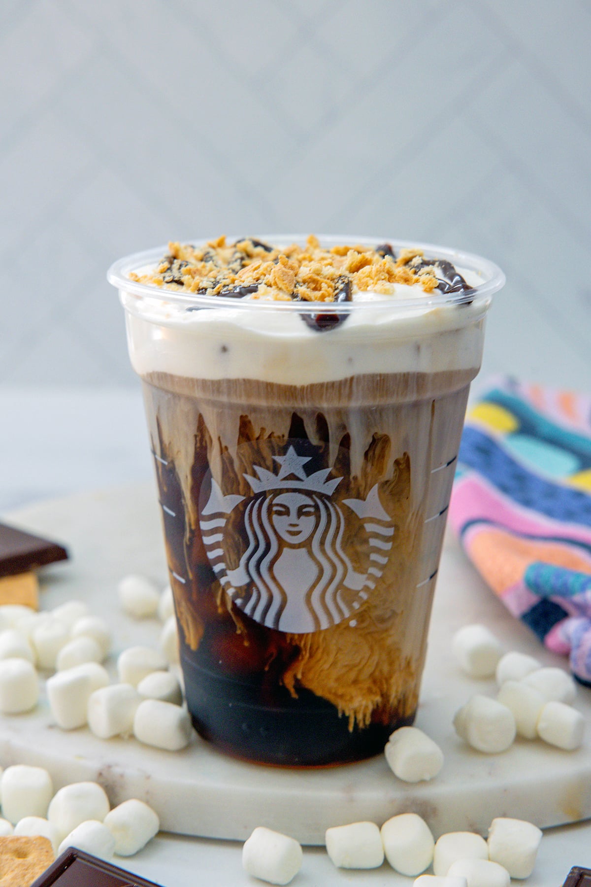 Head-on view of a s'mores cold brew topped with chocolate drizzle and graham cracker crumbs.