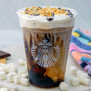 Closeup view of a S'mores Cold Brew with mini marshmallows all around.