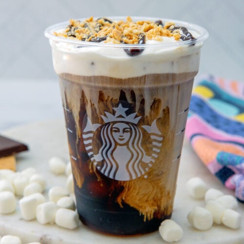 Closeup view of a S'mores Cold Brew with mini marshmallows all around.