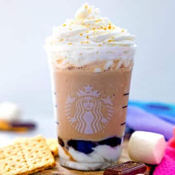 Closeup view of a S'mores Frappuccino topped with whipped cream and graham cracker crumbs.