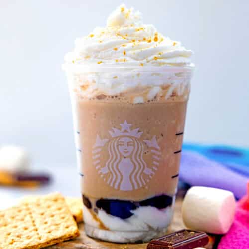 Closeup view of a S'mores Frappuccino topped with whipped cream and graham cracker crumbs.