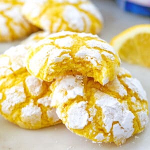 Close-up view of soft lemon cookies, one with a bite out of it.
