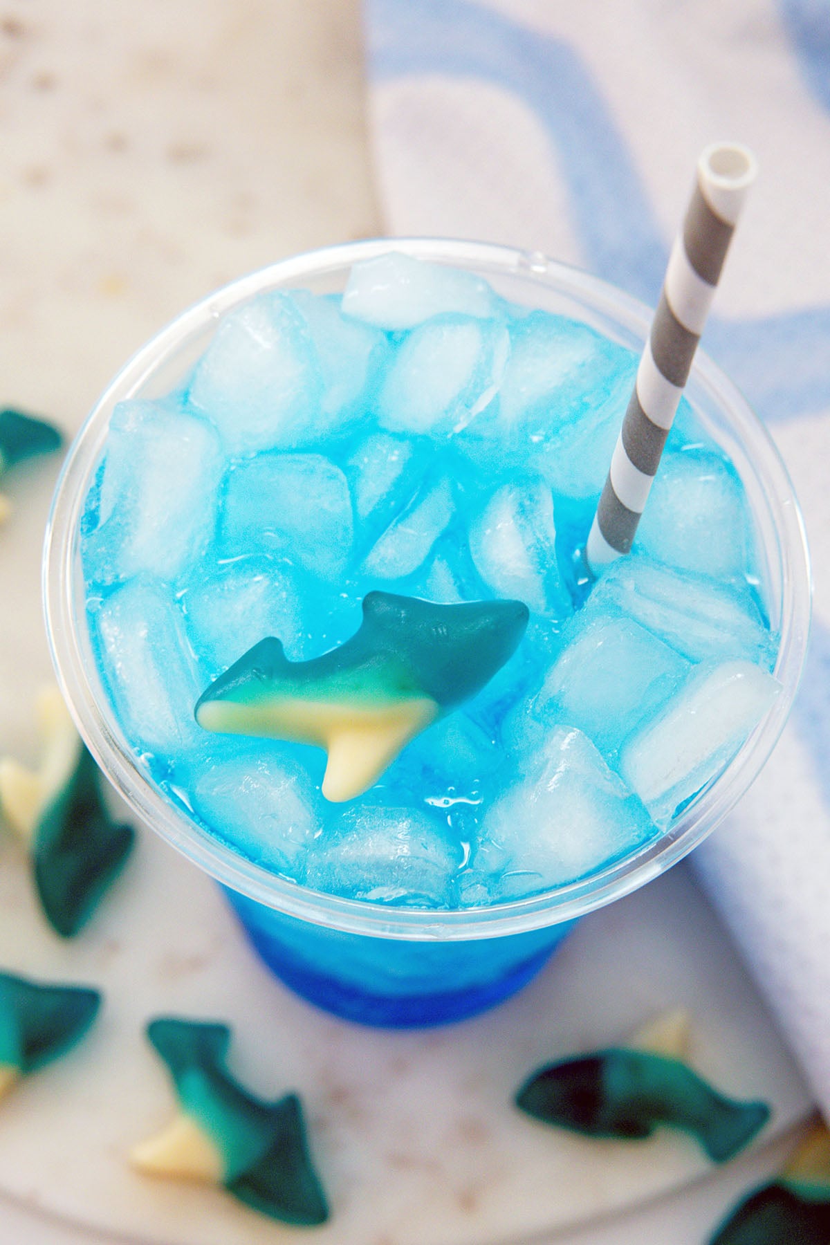 Overhead view of a blue Sonic Ocean Water with gummy shark floating in it.