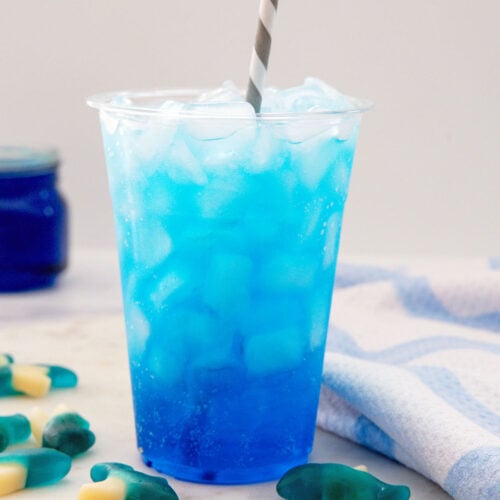Closeup view of a blue Sonic Ocean Water drink with straw.