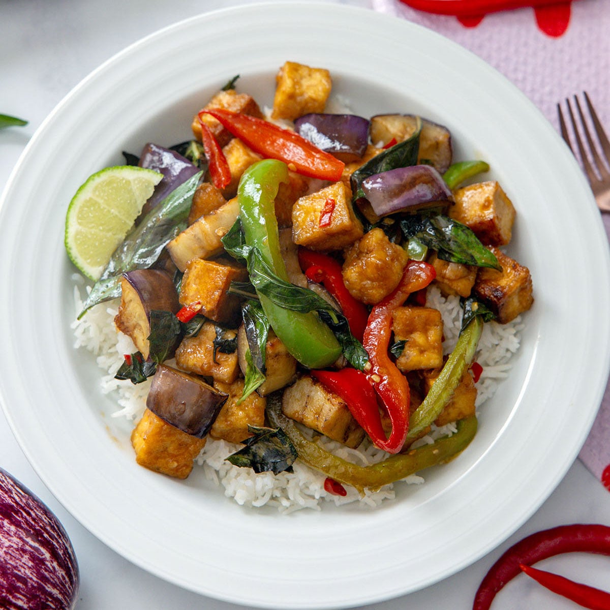 Closeup view of a bowl of spicy basil eggplant with tofu.