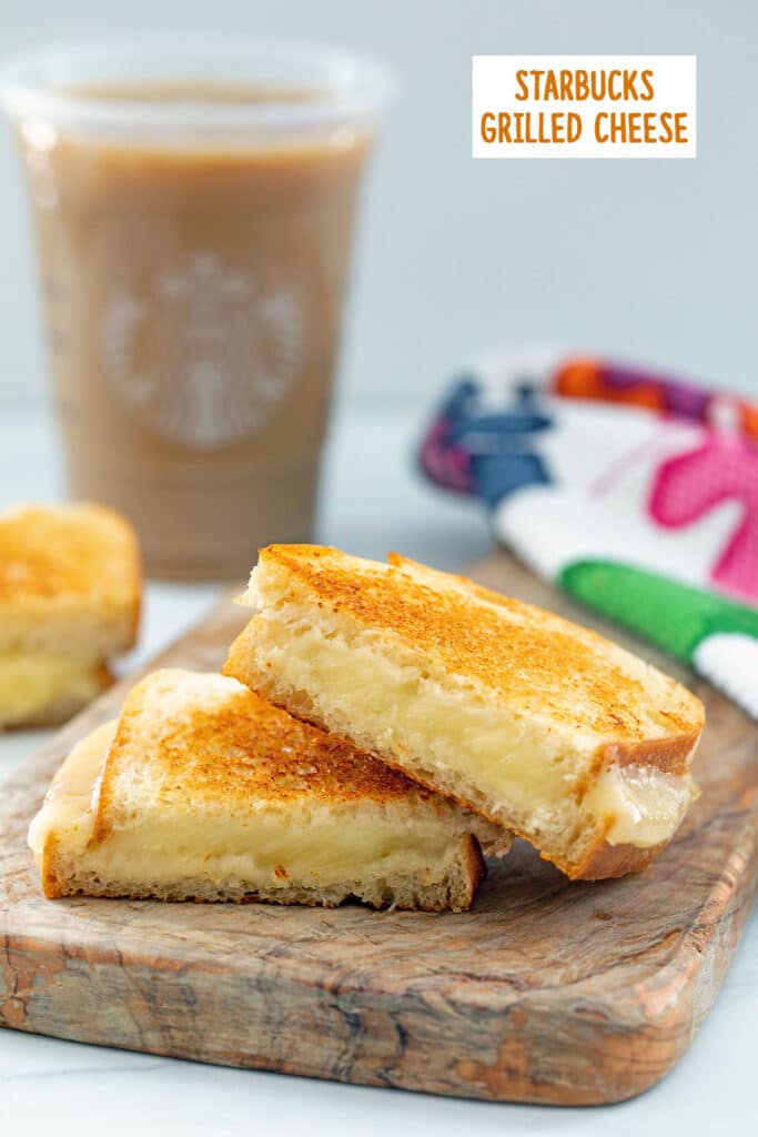 Head-on view of two halves of a grilled cheese sandwich on wooden board with Starbucks cup of iced coffee in background and recipe title at top.