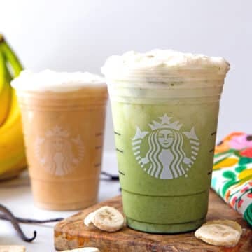 Head-on view of a protein matcha banana latte and an iced protein vanilla latte in Starbucks cups.