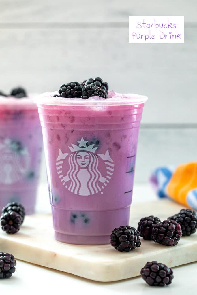 Head-on view of purple drink in a Starbucks cup with blackberries all around and recipe title at top.