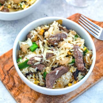 Overhead view of steak and cheese fried rice in a bowl.