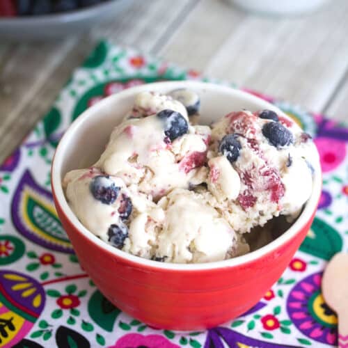 Closeup view of a bowl of blueberry strawberry ice cream in a bowl.