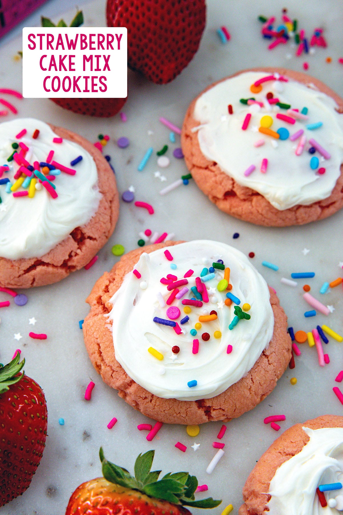Strawberry cake mix cookies with frosting and sprinkles with fresh strawberries all around and recipe title at top.