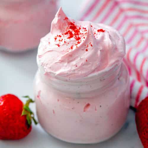 Closeup view of strawberry fluff in a small jar.