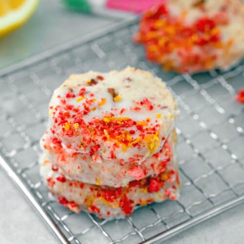 Closeup view of stack of strawberry lemonade shortbread cookies with crushed freeze-dried strawberries.