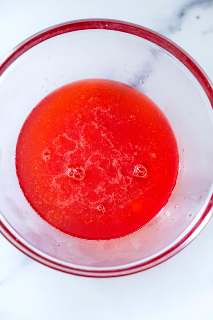Overhead view of strawberry lemonade syrup in bowl.