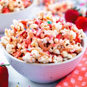 Close-up view of a bowl of strawberry popcorn with sprinkles.