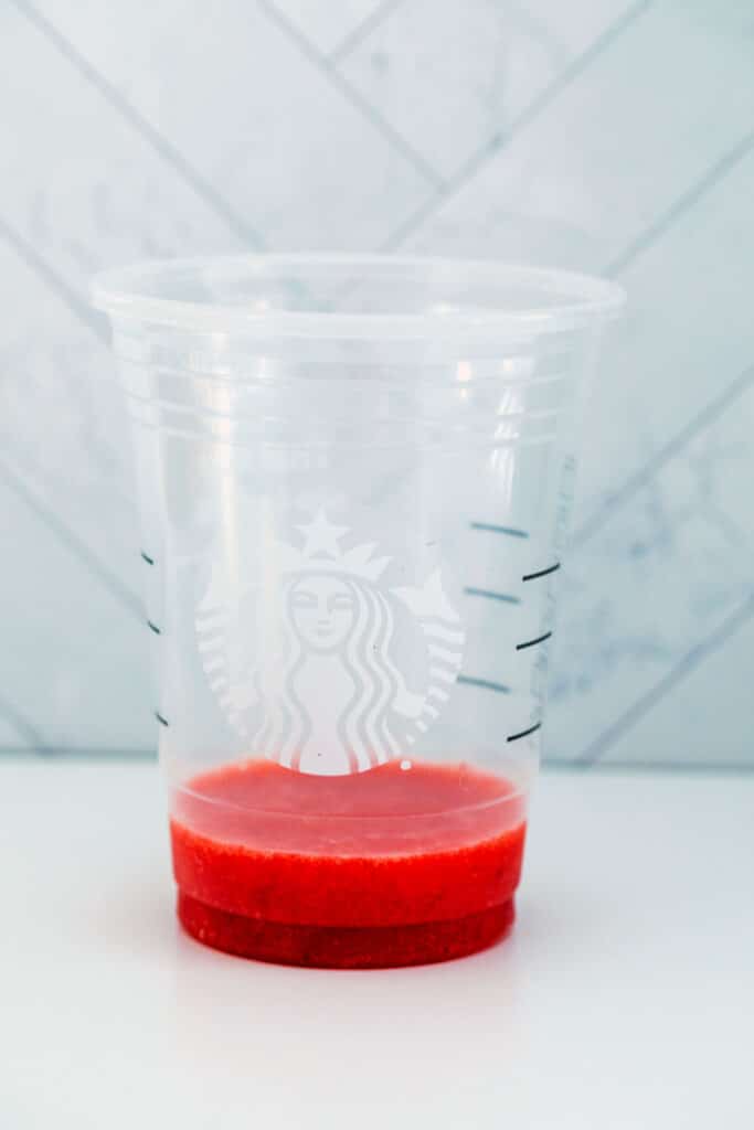 Strawberry puree at the bottom of a Starbucks cup.
