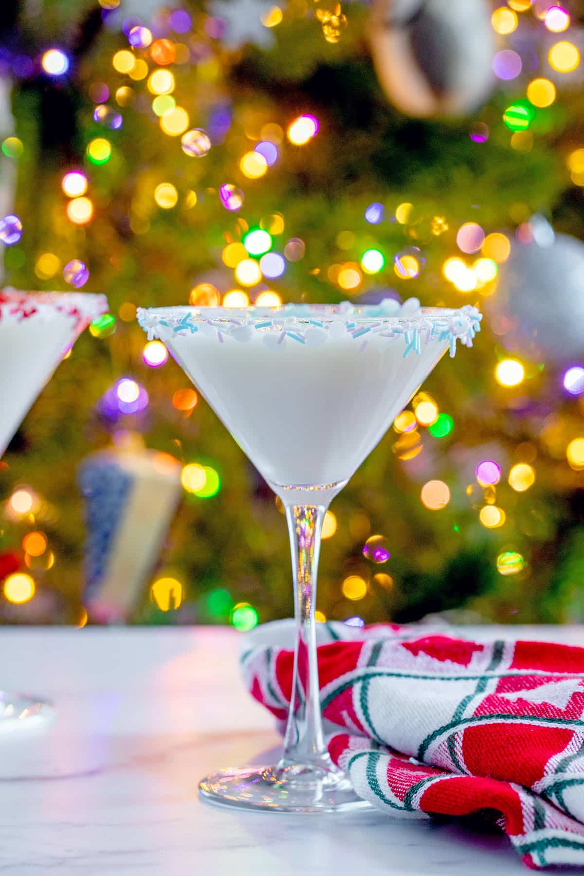 Head-on view of a sugar cookie martini by the Christmas tree.