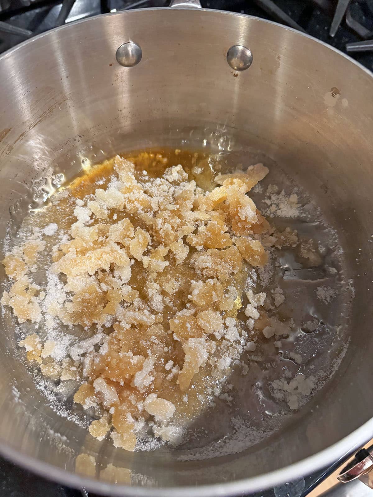 Sugar browning in saucepan.