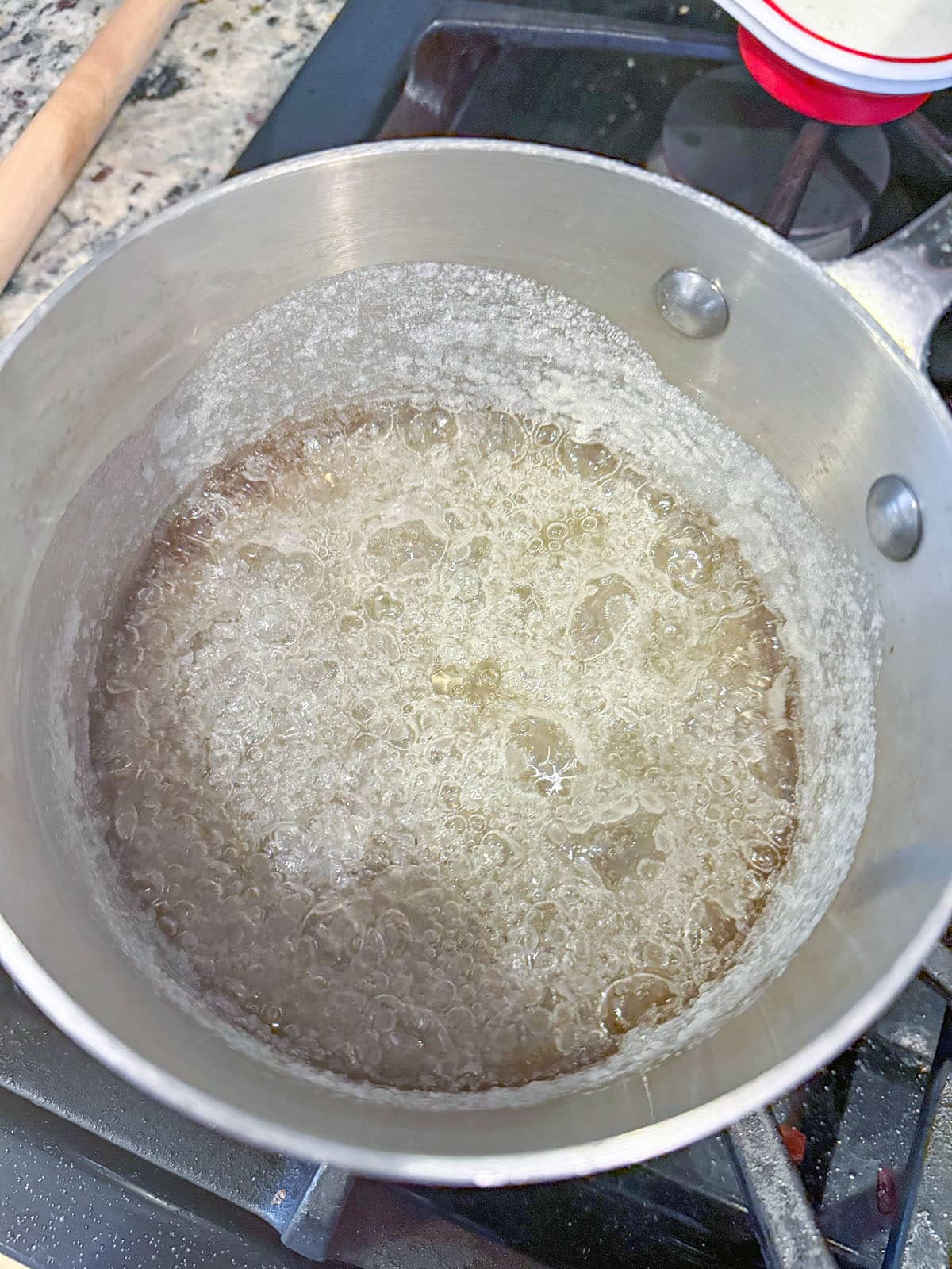 Sugar and water simmering in saucepan.