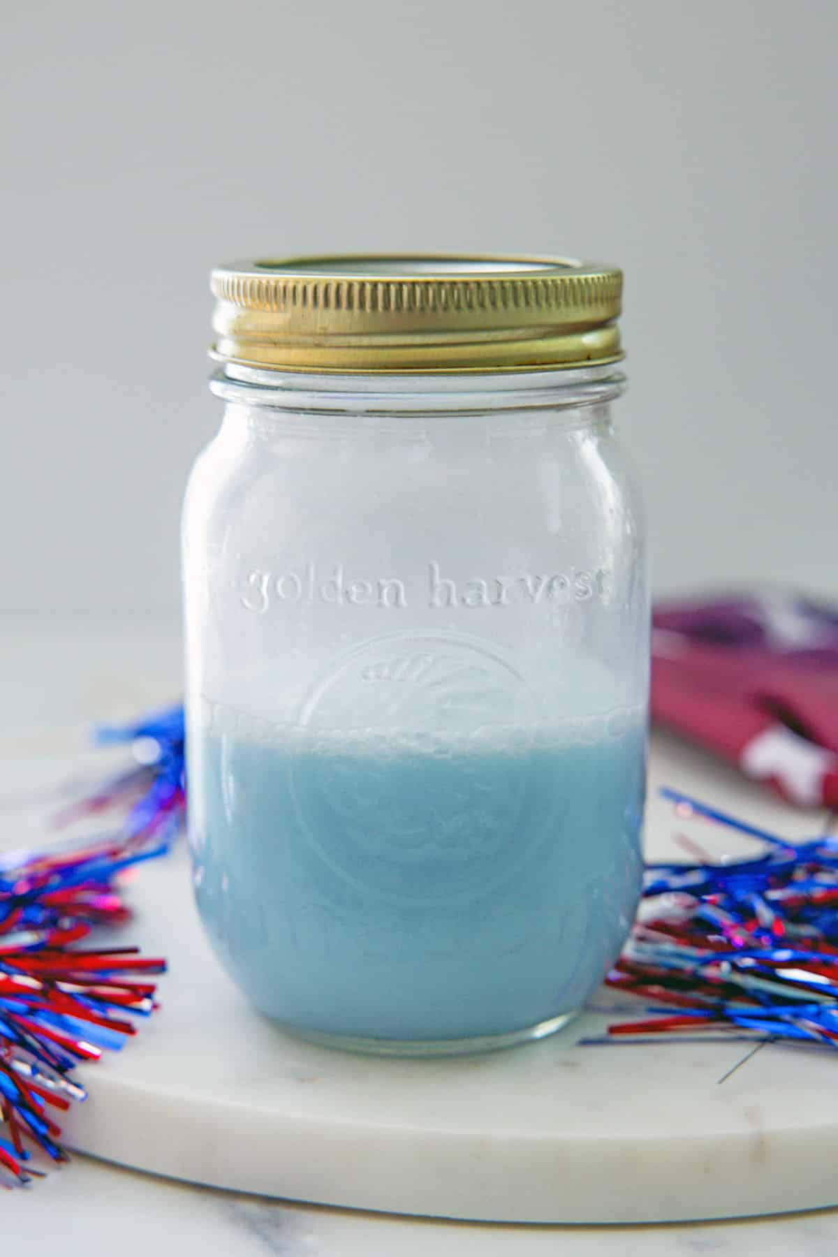 Summer Berry Refresher based mixed with coconut milk in a jar.