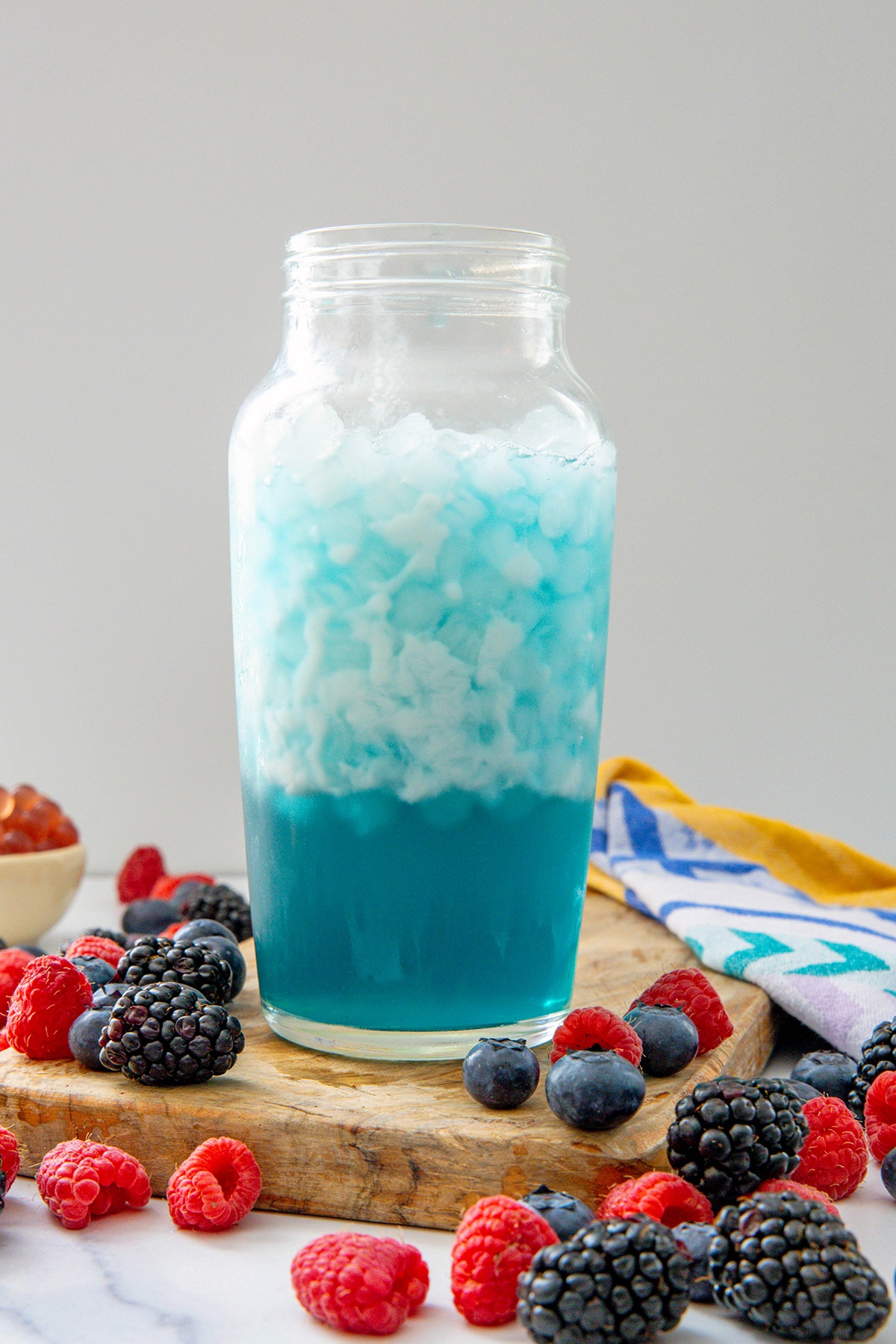 Summer-Berry Refresher base topped with coconut milk in clear shaker with ice.