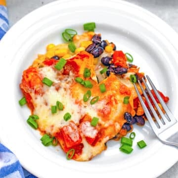 Overhead closeup of a piece of tex-mex lasagna on a plate with a fork.