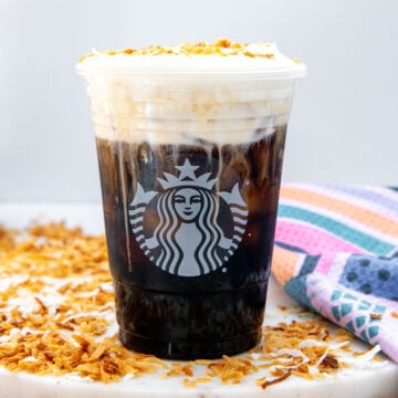 Closeup view of a a Toasted Coconut Cream Cold Brew with toasted coconut.