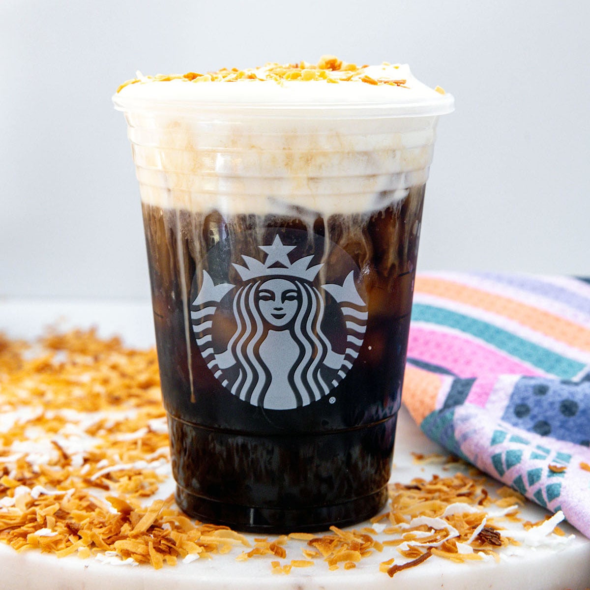 Closeup view of a a Toasted Coconut Cream Cold Brew with toasted coconut.
