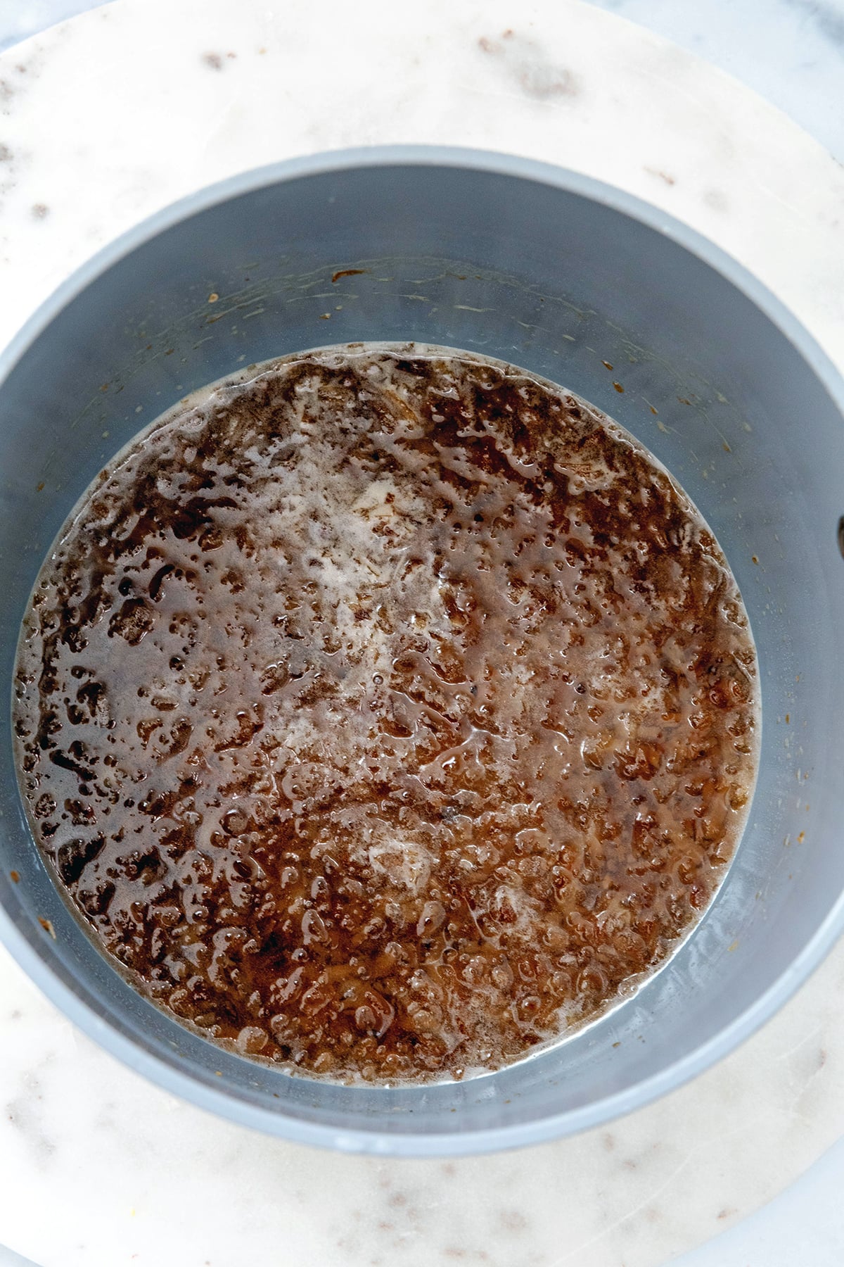 Toasted coconut simmering in water and sugar.