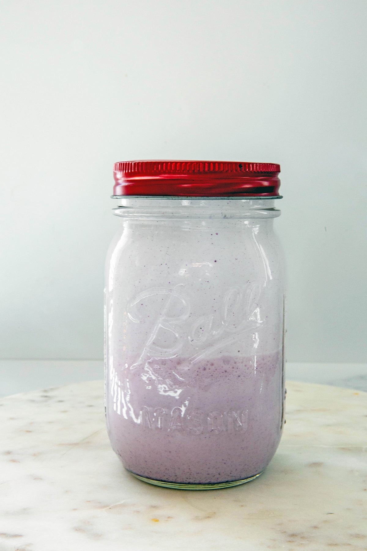 Purple ube coconut cold cream in a mason jar.