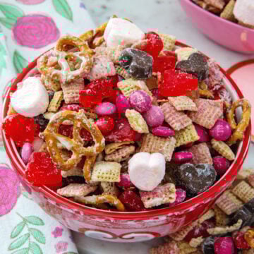 Closeup view of Valentine snack mix with pretzels, marshmallows, heart shaped candy, and more.