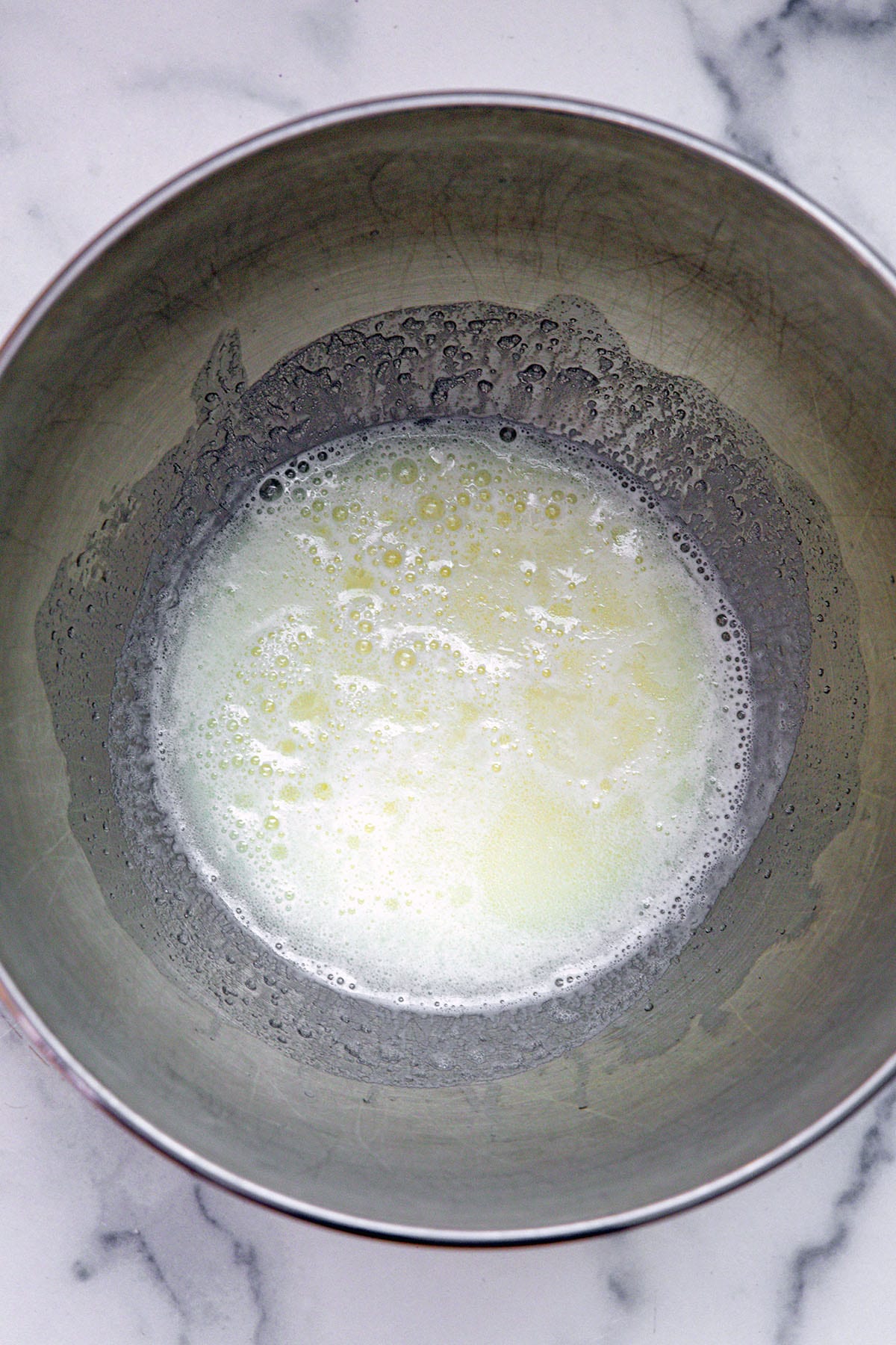Warmed milk in mixing bowl.