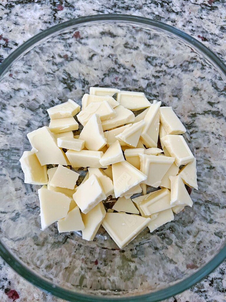Chopped white chocolate in a bowl.