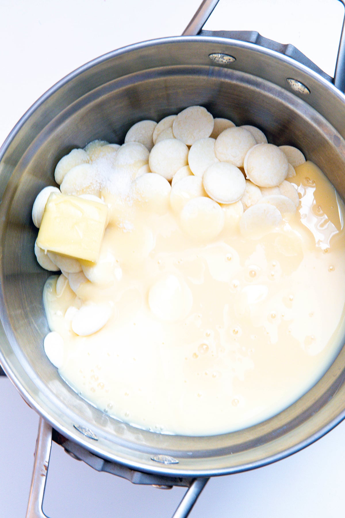 Overhead view of pot with white chocolate and butter.