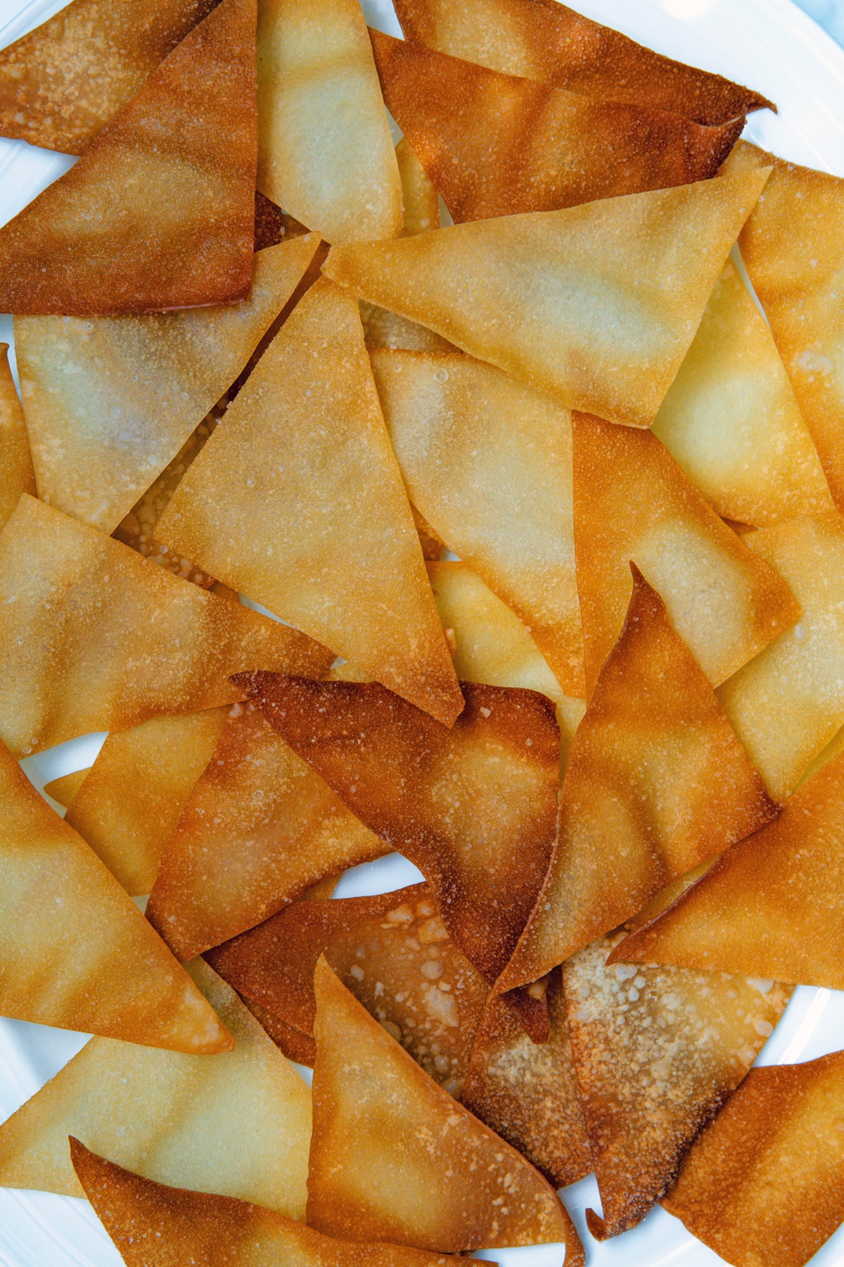 Fried wonton chips on a plate.